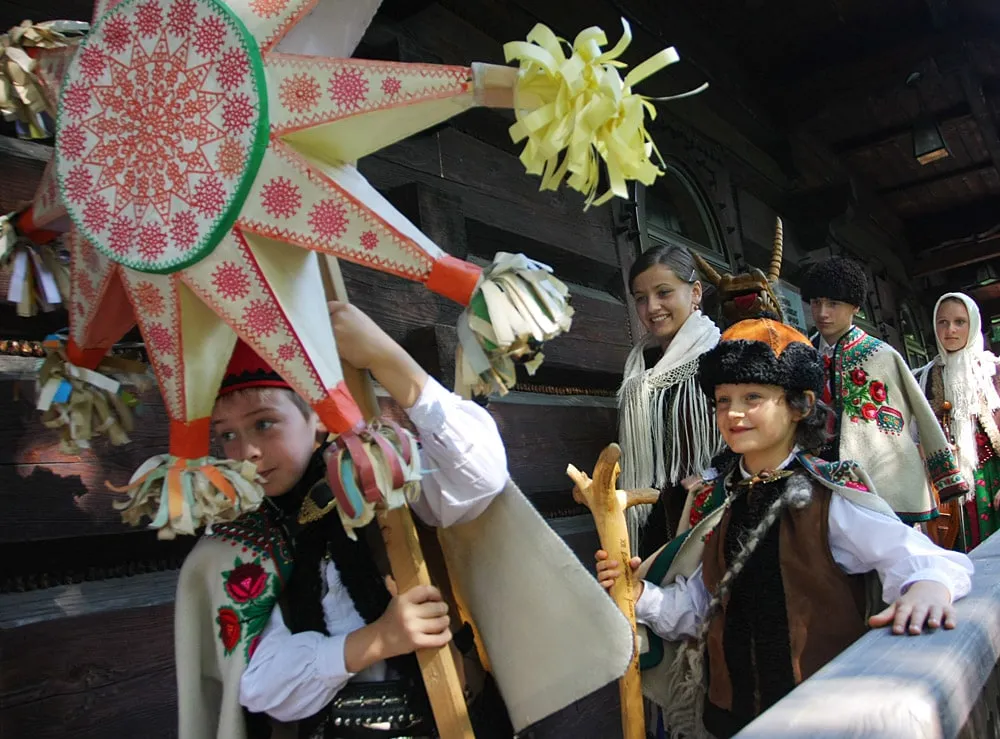 Children in highland folk costume carrying a carollers’ star in Zakopane