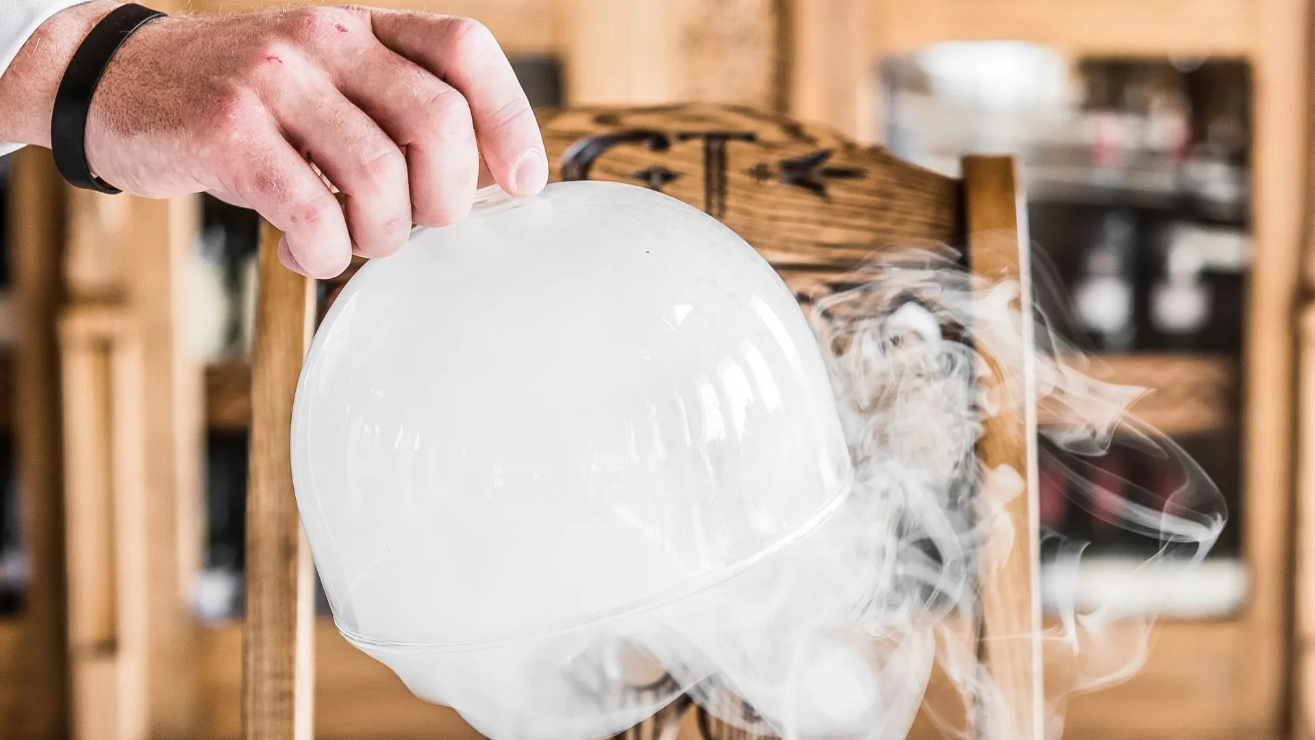 A plated dish being served under a cloche in a Zakopane restaurant