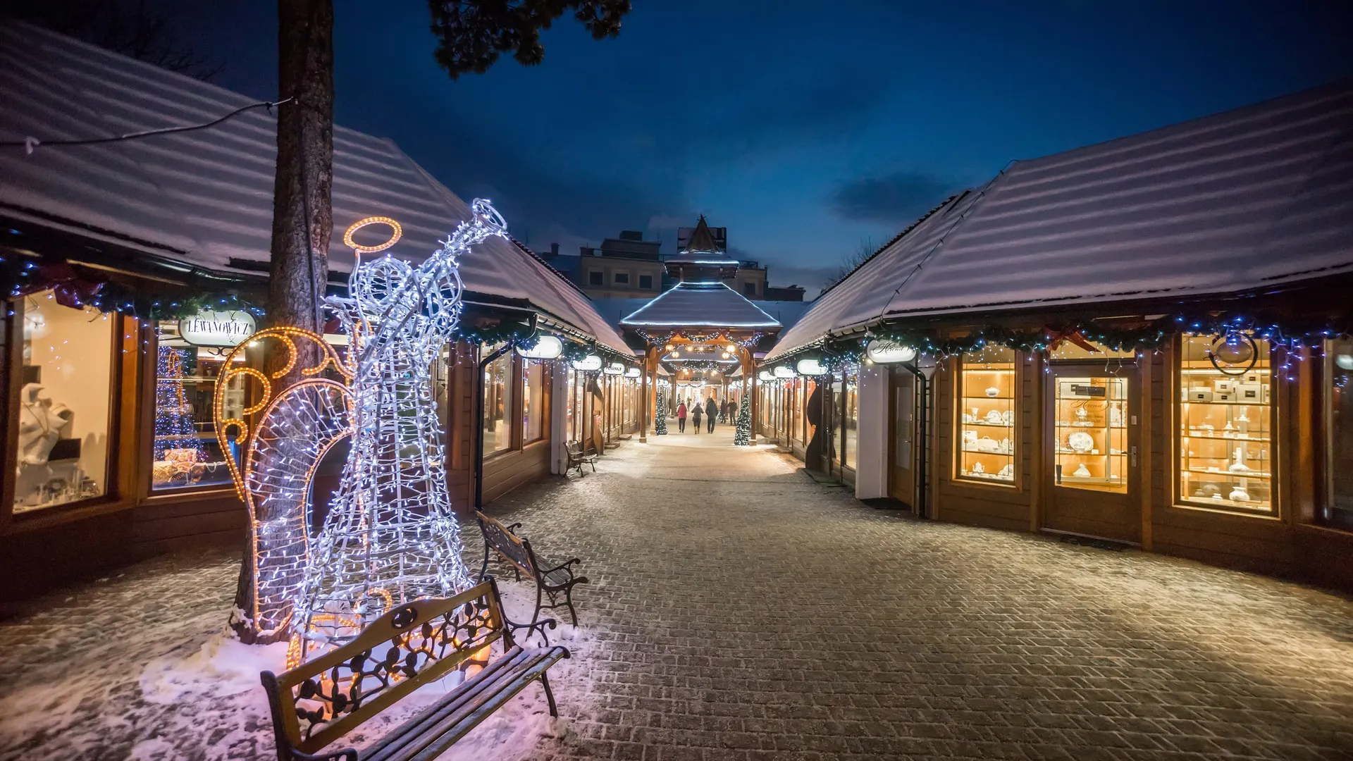 An illuminated shopping arcade in Zakopane on a winter evening